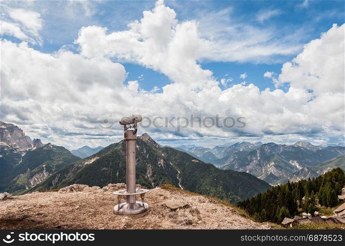 Binoculars on the background of the beautiful Mountain view. Italian Alps