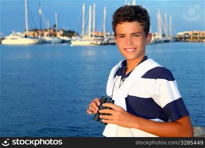 binoculars teenager boy on boat marina in blue summer vacation