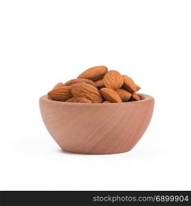 Bio organic almonds in wooden bowl isolated on white background.. Bio organic almonds in wooden bowl isolated on white background,