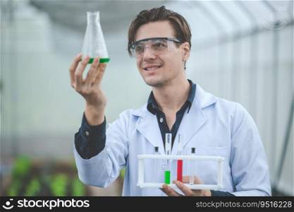 bio scientist in agriculture farm happy smile look at new chemical formula s&le extract from plant farm concept.