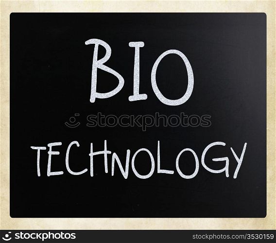 ""Bio technology" handwritten with white chalk on a blackboard."