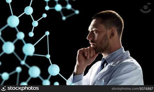 bio technology, science and people concept - male doctor or scientist in white coat looking at virtual projection of molecule over black background. scientist looking at molecule projection