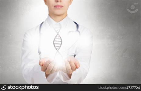 Biochemistry DNA molecule. Woman doctor showing DNA molecule hologram in palms