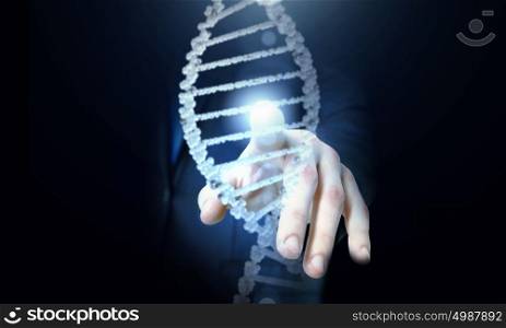 Biochemistry research. Science concept image of human hand touching DNA molecule