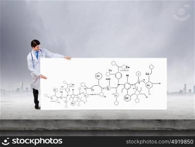 Biochemistry science. Young doctor with white banner presenting molecule research