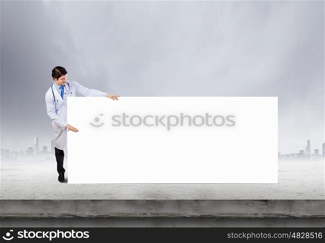 Biochemistry science. Young doctor with white blank banner. Place your text