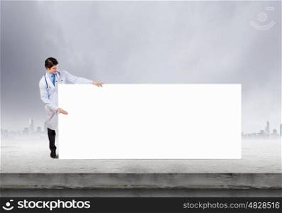 Biochemistry science. Young doctor with white blank banner. Place your text