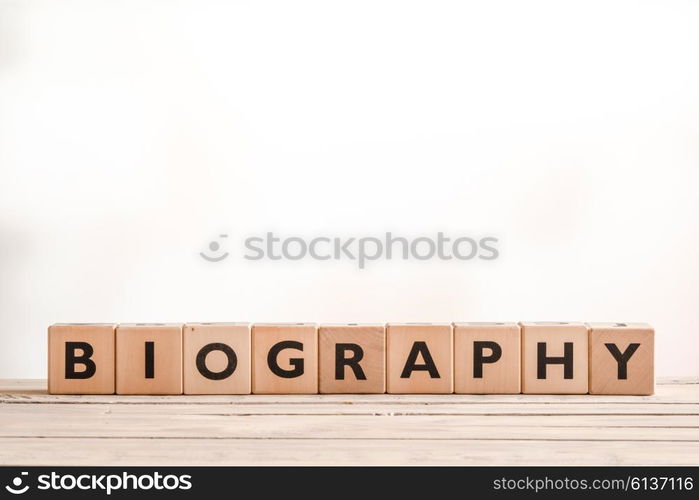 Biography headline sign made of wood on a table