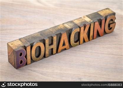biohacking - managing one&rsquo;s own biology using a combination of medical, nutritional and electronic techniques - word abstract in letterpress wood type