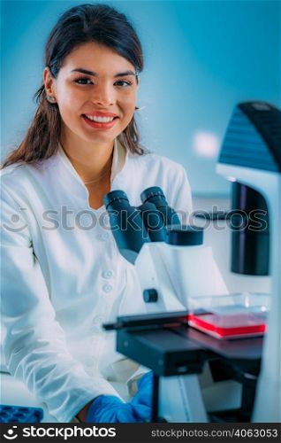 Biology Student Researcher Looking Through the Microscope