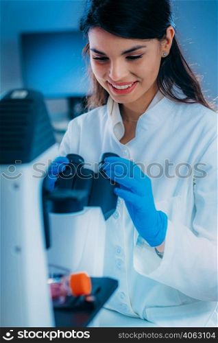 Biology Student Researcher Looking Through the Microscope