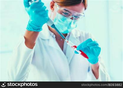 Biotechnology. Laboratory technician with micro pipette