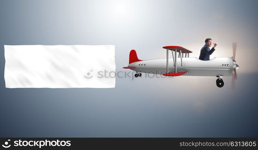 Biplane with businessman and blank banner