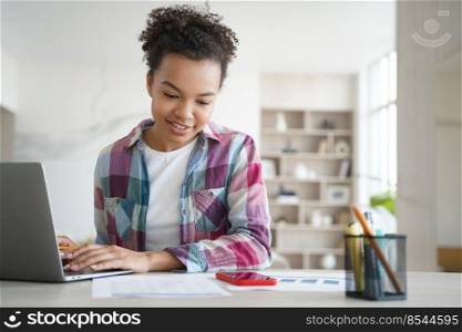 Biracial girl high school student doing homework at laptop reading social networks messages on smartphone. Mixed race teenage schoolgirl distracted from studying got message from friend in chat.. Biracial girl student distracted from studying at laptop, got message from friend on smartphone