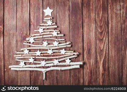 Birch branches and white stars in a shape of christmas tree. Eco Cristmas tree