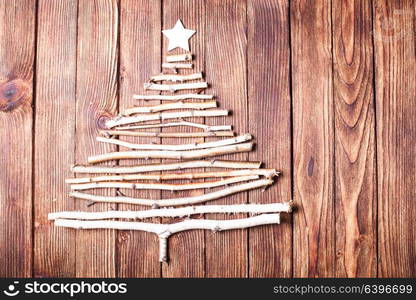 Birch branches and wooden star as a decor for Christmas with copy space. Eco Cristmas tree