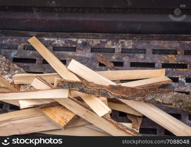 Birch firewood on the grill grate. Cooking food. Birch logs on the grill Cooking food