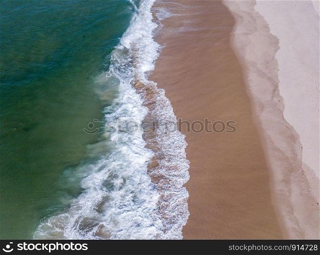 Bird eye perspective of waves hitting the beach on the Swahili coast, Tanzania.