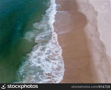 Bird eye perspective of waves hitting the beach on the Swahili coast, Tanzania.