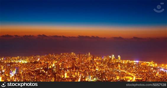 Bird eye view of beautiful night cityscape, many glowing lights in nighttime in Lebanon, picturesque scene, travel and tourism concept