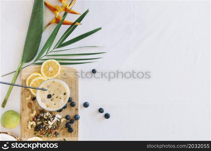 bird paradise flower with healthy smoothies with dryfruits white background