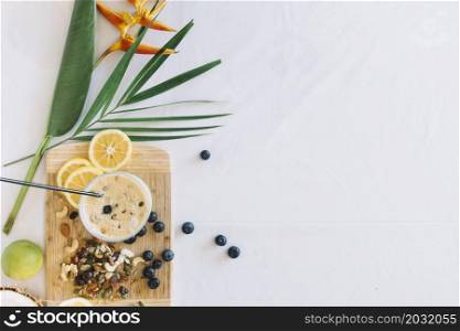 bird paradise flower with healthy smoothies with dryfruits white background