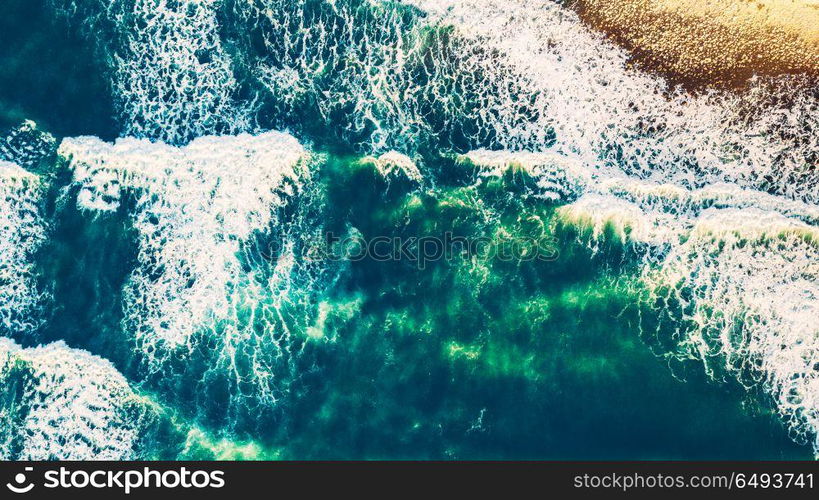 Bird&rsquo;s eye view on the open waters of planet earth, stormy seas, blue turquoise water of an ocean with waves and foam, abstract natural background, drone photography. Aerial view of the ocean