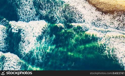 Bird&rsquo;s eye view on the open waters of planet earth, stormy seas, blue turquoise water of an ocean with waves and foam, abstract natural background, drone photography. Aerial view of the ocean