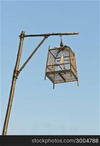 Birdcage lamp in blue sky