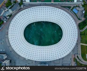 Birds eye panoramic view from drone of the football stadium with ocean turquoise water inside roof. Top view.. Top football stadium with sea water.