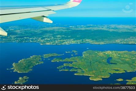 Birds eye. View from window of plane airplane flying over Norway Scandinavia.