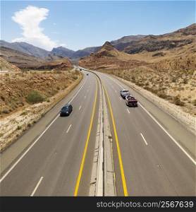 Birds eye view of automobiles on rural desert highway.