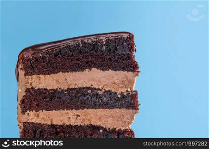 Birthday cake slice with chocolate filling. Close-up of chocolate layered cake with buttercream icing. Macro with chocolate frosting birthday cake