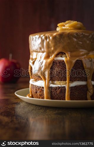 Birthday cake with apples and yogurt filling, decorated with caramel sauce. Delicious layered cake with caramel glaze. Easy to make festive dessert.