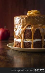 Birthday cake with apples and yogurt filling, decorated with caramel sauce. Delicious layered cake with caramel glaze. Easy to make festive dessert.