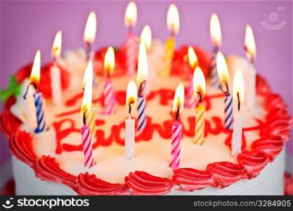 Birthday cake with burning candles and icing
