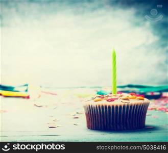 Birthday cake with candle on table at turquoise blue background ,front view