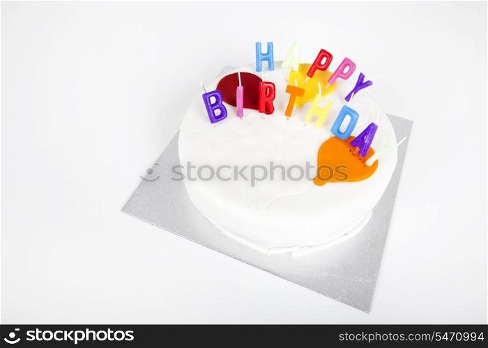 Birthday cake with candles against white background