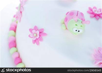 birthday cake with white frosting and ladybugs