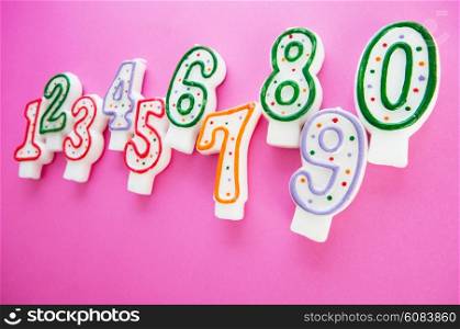 Birthday candles against colourful background