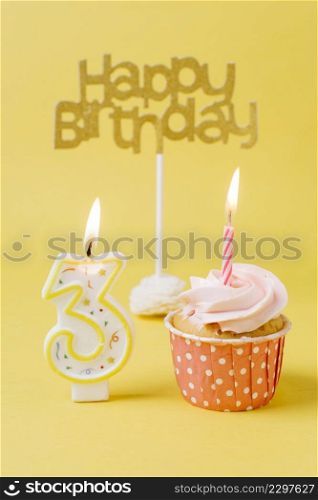 birthday cupcake with lit candle