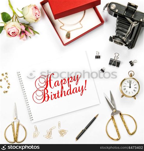 Birthday flat lay background with gift box and rose flowers. Sample text Happy Birthday! Greetings card concept