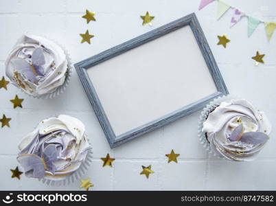 Birthday holiday cupcakes with butterfly decorations and picture frame - holiday background