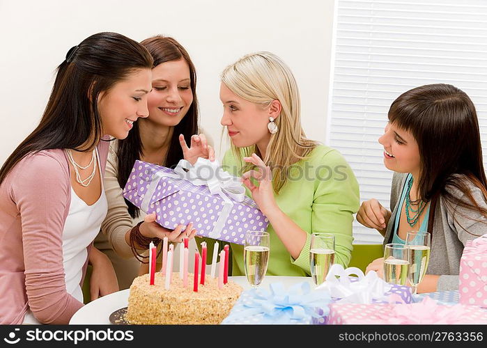 Birthday party - happy woman getting present, champagne, cake