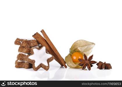 Biscuit in the cinnamon and the star anise with physalis on white background