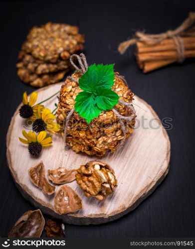 biscuit oatmeal flakes, bananas and walnuts on a wooden stand, top view