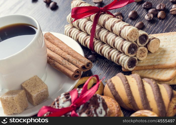 Biscuits and coffee on table. Assorted biscuits and sweets with a cup of coffee on table