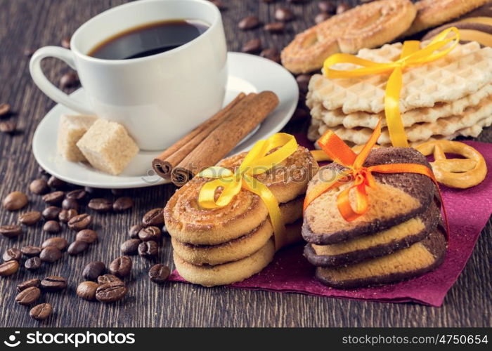 Biscuits and coffee on table. Assorted biscuits and sweets with a cup of coffee on table