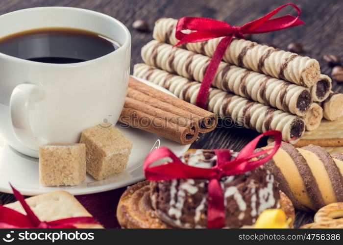 Biscuits and coffee on table. Assorted biscuits and sweets with a cup of coffee on table