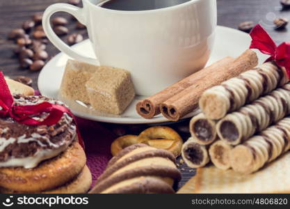 Biscuits and coffee on table. Assorted biscuits and sweets with a cup of coffee on table